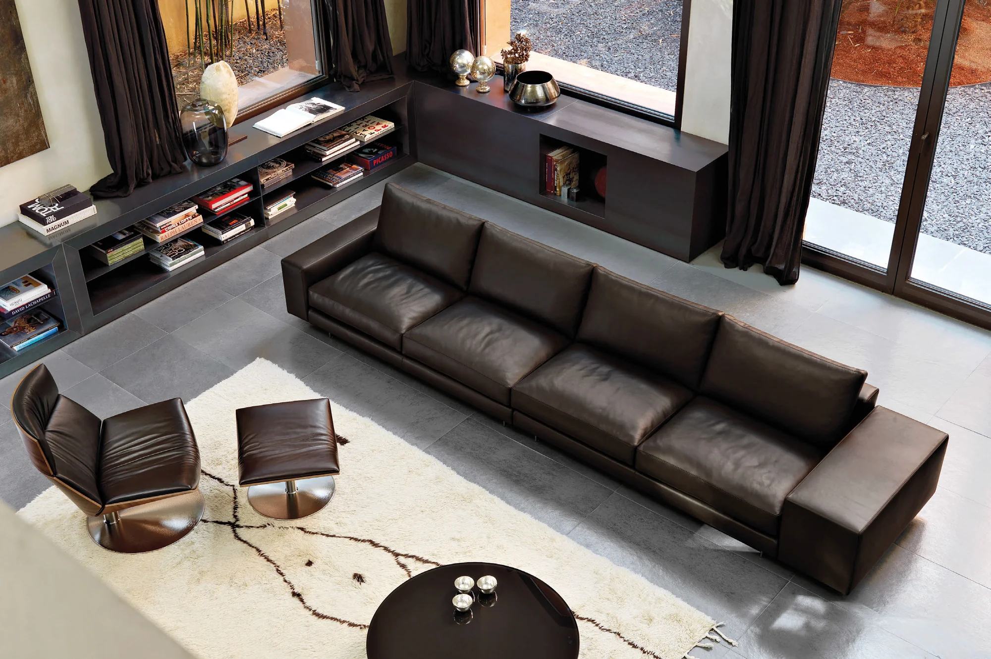 Modern Villa Interior, black leather sofa and low tables in a contemporary living room