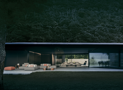 Illuminated modern pavilion with outdoor furniture beneath a wooded hillside