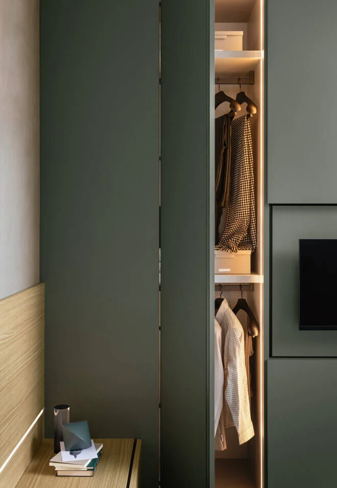 Open Alterna hinged door showing illuminated hanging rails and shelves